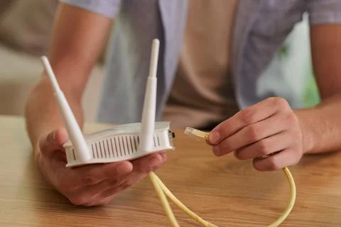 Inserting Ethernet Cord in Router Stock Photos