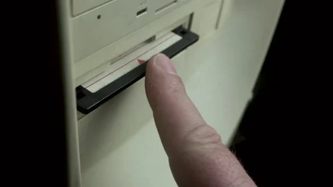 Inserting EXE Program Start Up File on Floppy Disk Into PC Computer Drive, Stock Footage 180406441
