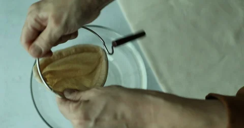 Inserting flannel cloth filter into a metal holder for flannel drip coffee Stock Footage 117680177