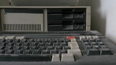 Inserting a floppy disk in retro personal computer Stock Footage 91299815