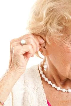 Inserting Hearing Aid Foto stock