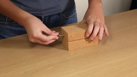 Inserting a Hook into a Wooden Block Stock Footage 306904588