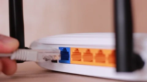 Inserting internet cable to wan nest of router Stock Footage 88764163
