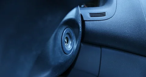 Inserting key into car ignition - close up - 2006 year car Stock Footage 128663186