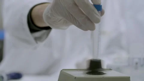 Inserting medical Sample in Laboratory Vortex Mixer Stock Footage 311418805