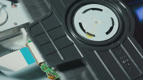 Inserting medium and reading DVD disc in players mechanism rotating fast Stock Footage 58425666
