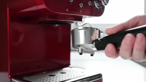 Inserting a metal horn into a red coffee machine in slow motion. Side view Stock Footage 165212277