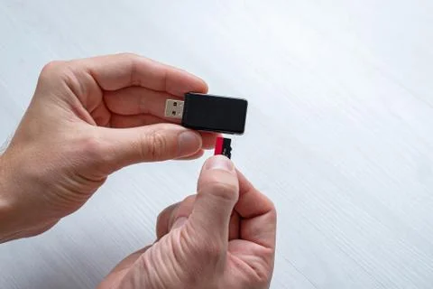 Inserting mini SD memory card in card reader concept. Hand holding memory car Stock Photos