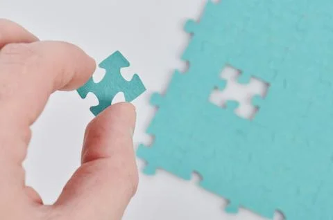 Inserting missing puzzle piece Stock Photos