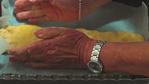 Inserting the mixture into the pan for the preparation of homemade biscuits Stock Footage 242068021