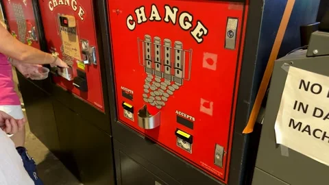 Inserting money into a change machine at the pinball Hall of Fame in Las Vega 動画素材 246610433