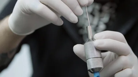 Inserting the needle in an electric tattoo machine. Stock Footage 83277334