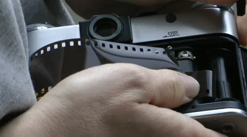 Inserting negative into an old 35mm camera  Stock Footage 11286576