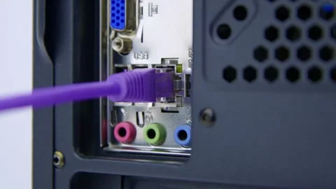 Inserting a Network Cable into a LAN Socket on the Rear of a Desktop PC Stock Footage 276274257