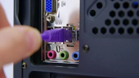 Inserting a Network Cable into a LAN Socket on the Rear of a Desktop PC Stock Footage 276274273