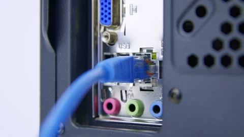 Inserting a Network Cable into a LAN Socket on the Rear of a Desktop PC Stock Footage 276274278