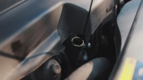Inserting an oil dipstick into a car engine, close-up. Vehicle lubrication 스톡 동영상 256874604