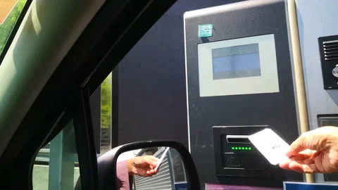Inserting parking pass on machine. Stock Footage 130947149
