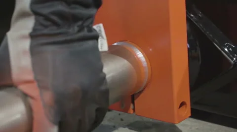 Inserting of a pipe metal on the orange block Stock Footage 59796720