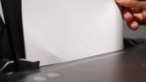 Inserting plain paper into a printer for printing tasks Stock Footage 333395590