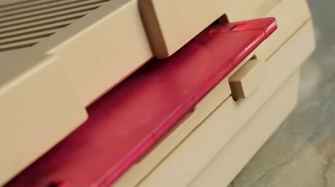 Inserting plastic pink floppy disk in  retro style personal computer 4K 2160p Stock Footage 53816733