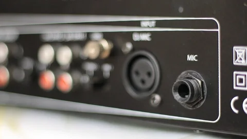 Inserting the plug cord into the microphone output Video stock 86214049