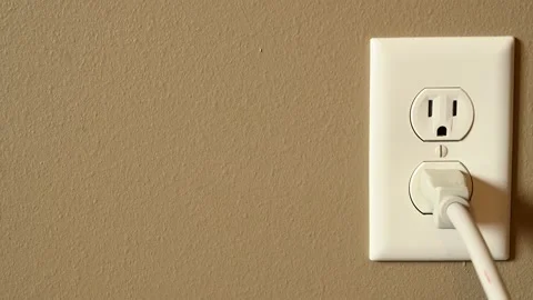 Inserting plug into outlet Stock Footage 138671803