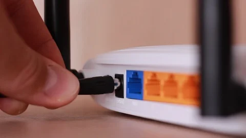 Inserting power cable to router Stock Footage 88764107