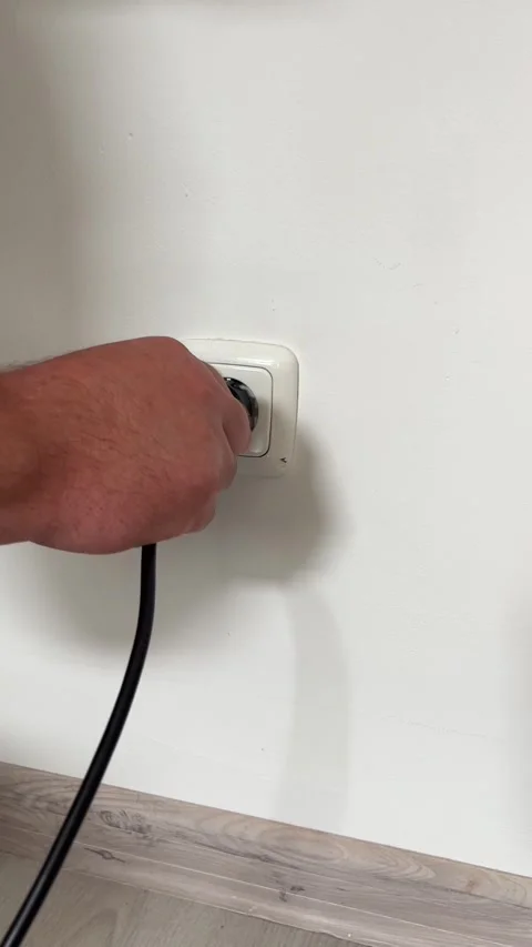 Inserting Power Plug Stock Footage 310564123