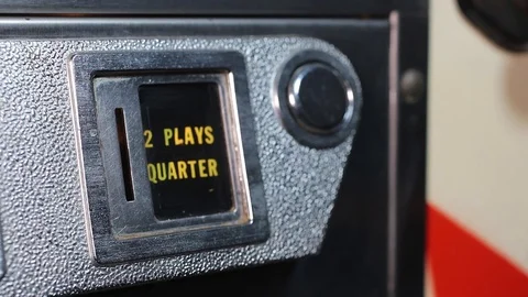 Inserting a quarter into an classic vintage EM pinball machine Stock Footage 119659067