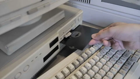 Inserting Retro 5.25 and 3.5 Inch floppy disk Stock Footage 157961215