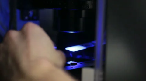 Inserting sample in modern microscope Stock Footage 34315677
