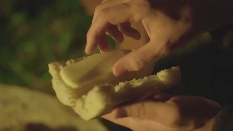 Inserting sausages inside bun at camp Stock Footage 141080295