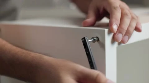 Inserting Screw Bolt to Join Wooden Shelf Panels Video stock 344145632