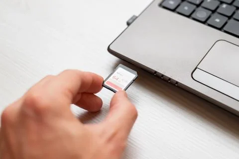 Inserting SD card in Laoptop computer close-up Stock Photos