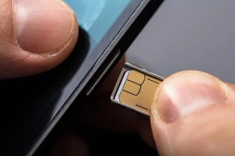 Inserting A Sim Card In A Mobile Phone Stock Photos