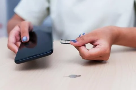 Inserting a sim card into a smartphone Stock Photos