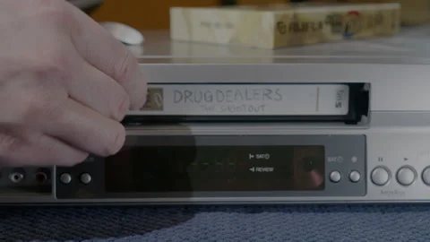 Inserting tape into vintage VHS player Stock Footage 229191017