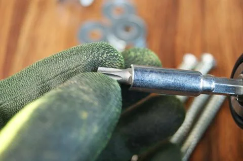 Inserting a Torx Bit into the Bit Adapter. Work process of the builder. Stock Photos
