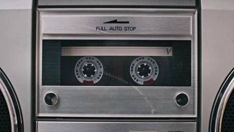 Inserting Transparent Cassette into Silver Boombox and Playing Video stock 303894261