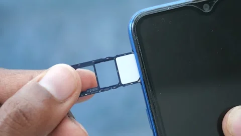 Inserting two nano sim cards and one micro sd memory card into a dual sim s.. Stock Footage 332745071