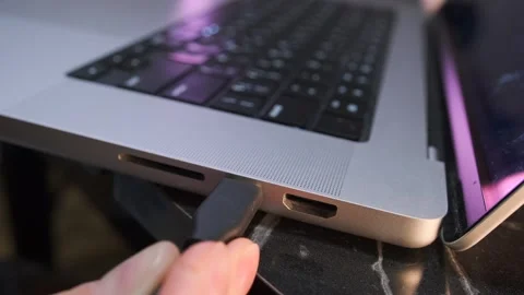 Inserting the USB-C cable into the laptop case Stock Footage 333470426