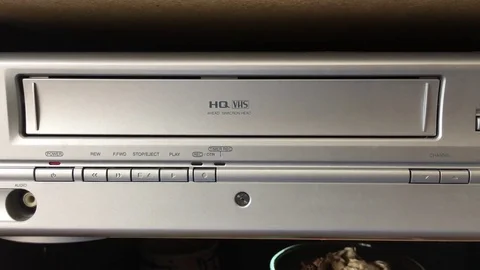 Inserting VHS Tape into VCR Close Up Stockbeeldmateriaal 79226734