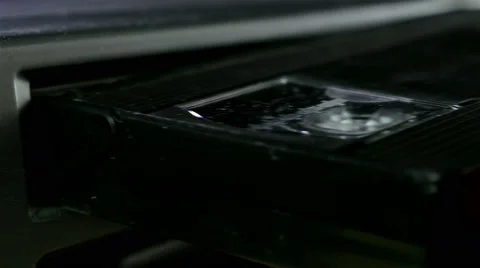 Inserting a VHS Tape into a VCR Player Stock Footage 62271094