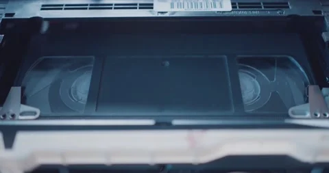 Inserting VHS video tape into retro VCR ... | Stock Video | Pond5