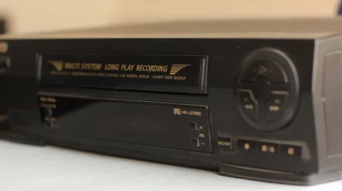 Inserting the video cassette into the VCR Stock Footage 49129669