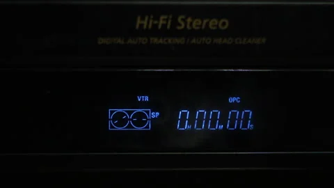 Inserting a video tape into the VHS player 動画素材 153616589