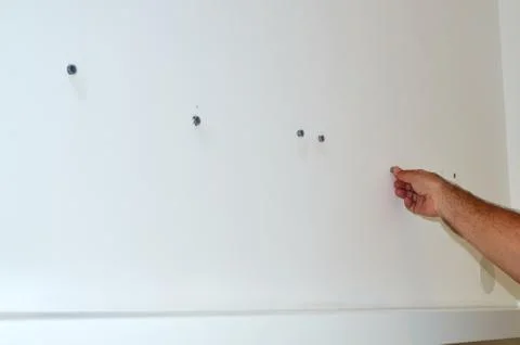 Inserting wall screw plugs Stock Photos