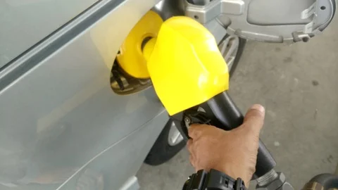 Insertion of the nozzle and pumping gasoline into vehicle at the gas station. Stock Footage 87427353