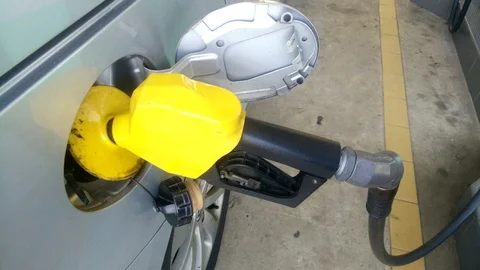 Insertion of the nozzle and pumping gasoline into vehicle at the gas station. Stock Footage 87483393